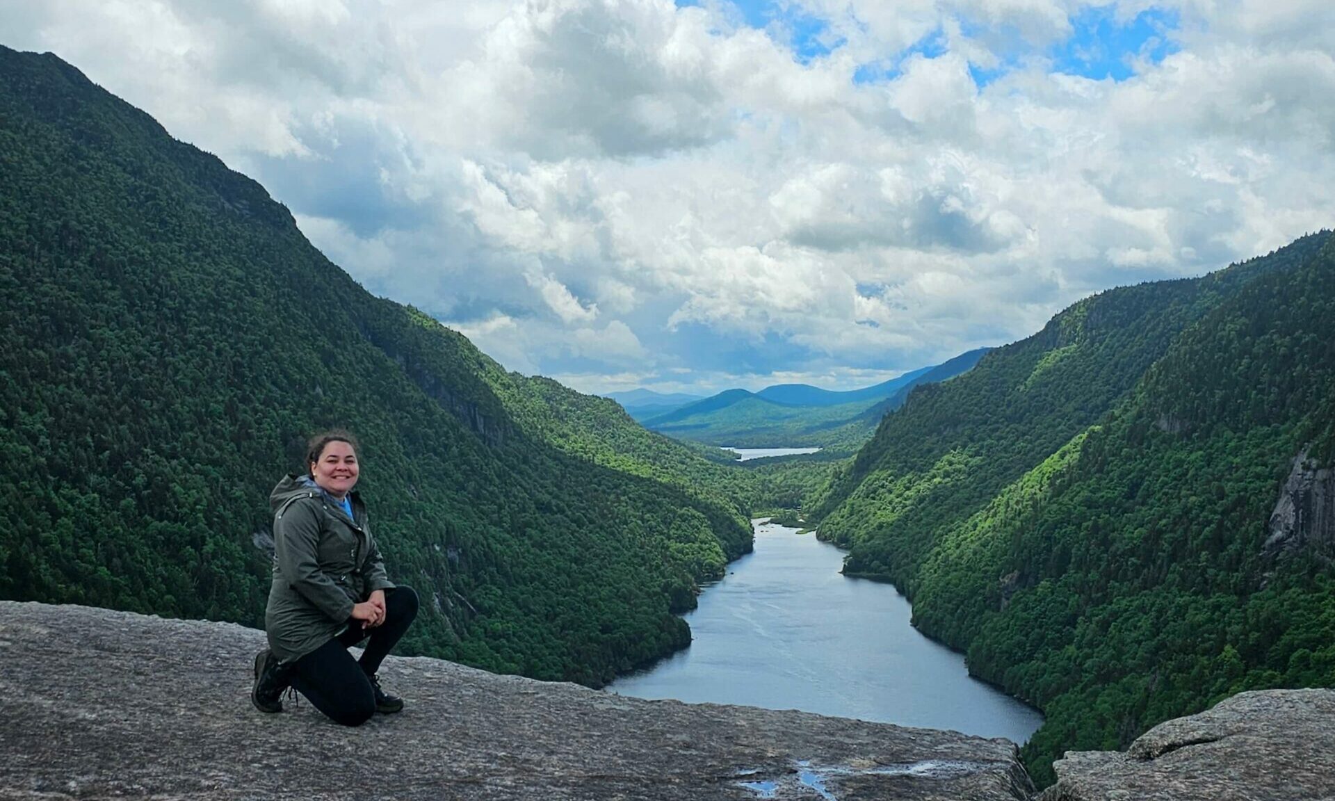 Luana posing on top of a rock while hiking