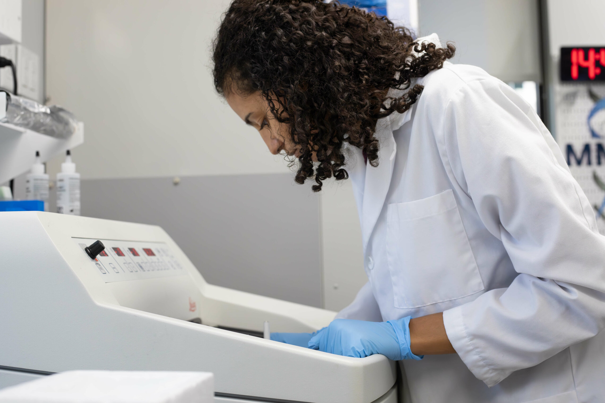 Scientist putting samples into a machine