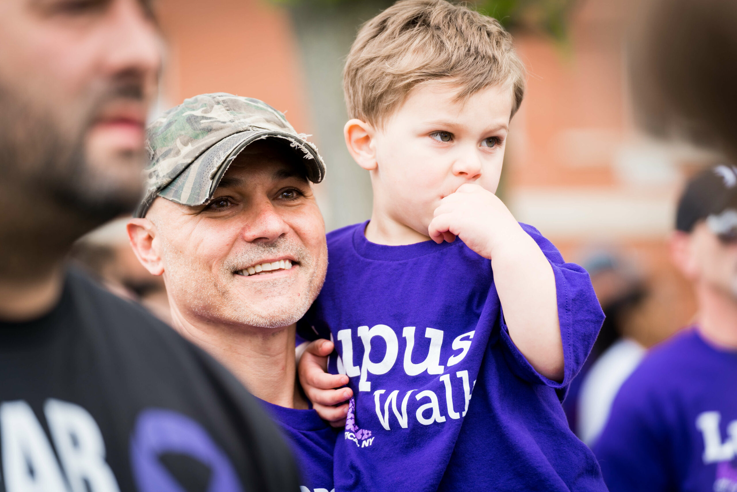 Walker holding son