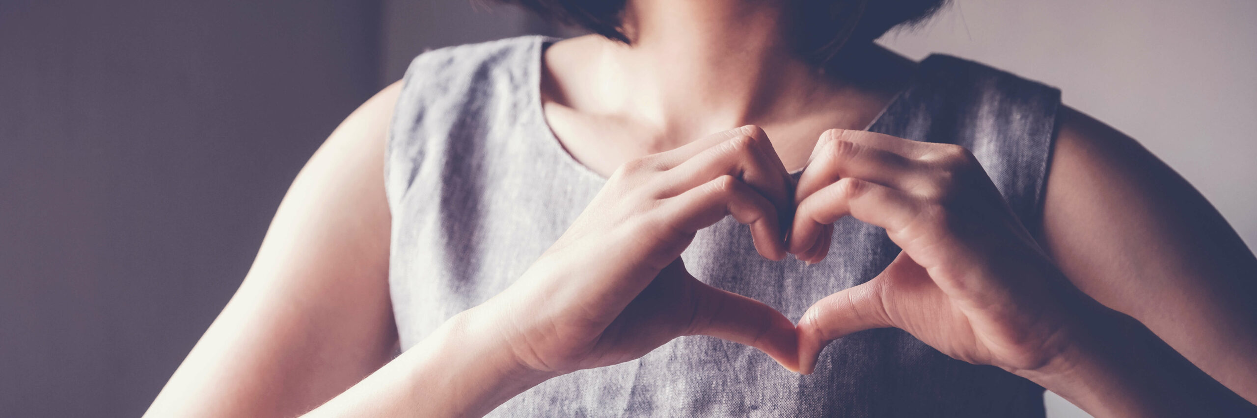 women making a heart with her hands