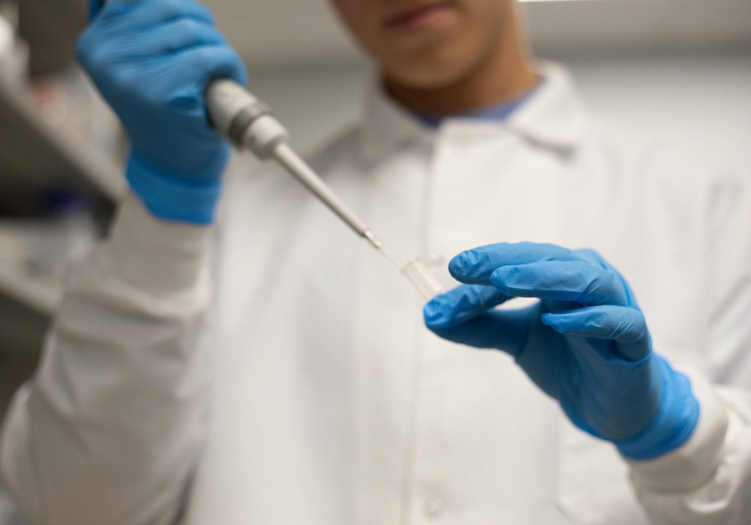 Lab technician using a dropper